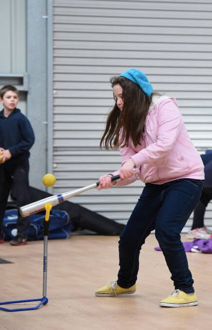 SMACK: Ella Baldwin hits the ball during the T-Ball Smash clinic run at California Gully Primary School. Picture: JODIE DONNELLAN