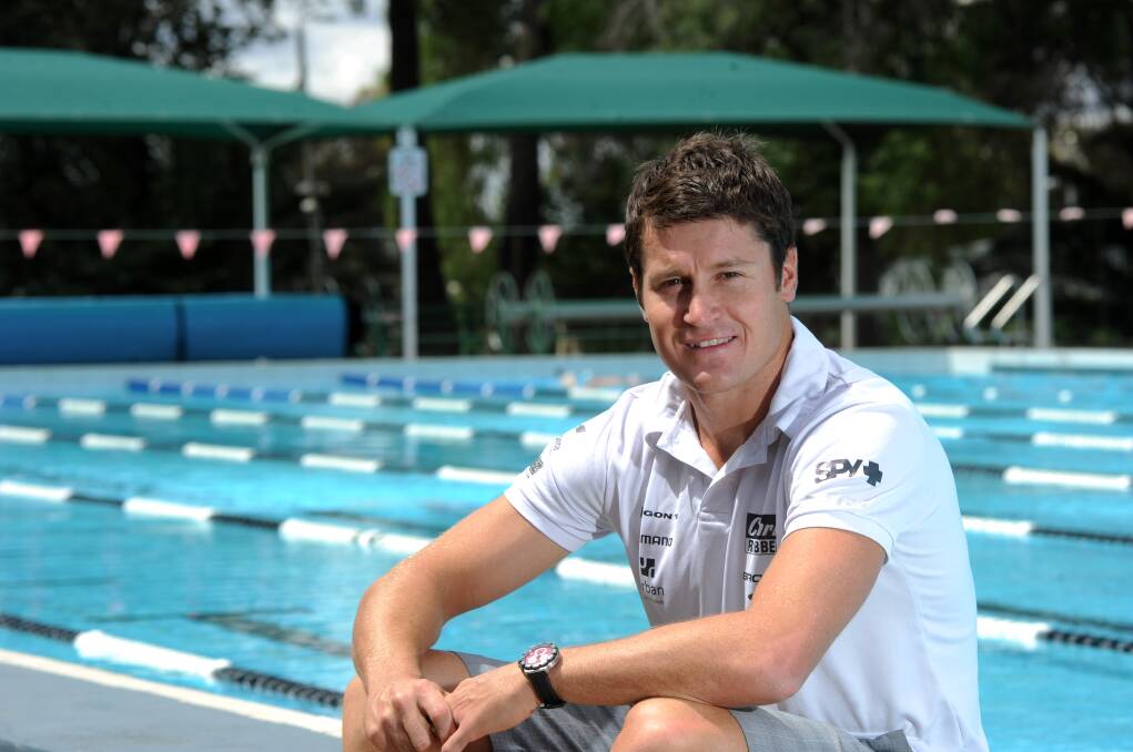 TAKING IT EASY: Top triathlete Leon Griffin relaxes by the Bendigo East Swimming Pool, the venue where his swimming career began many years ago. Picture: JODIE DONNELLAN