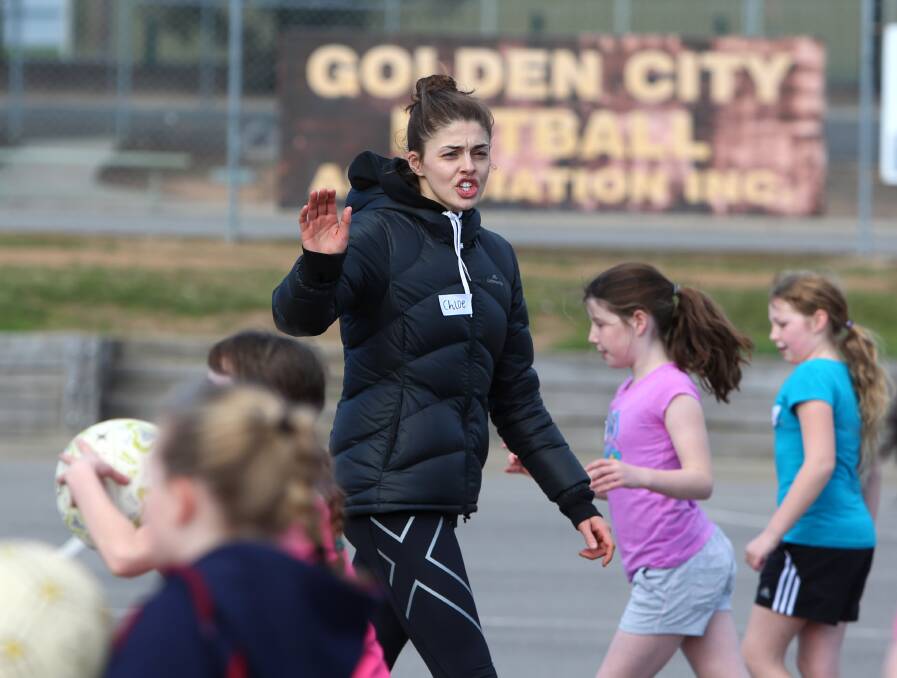 Chloe Watson helps out at a netball clinic in Bendigo in August. Picture: GLENN DANIELS