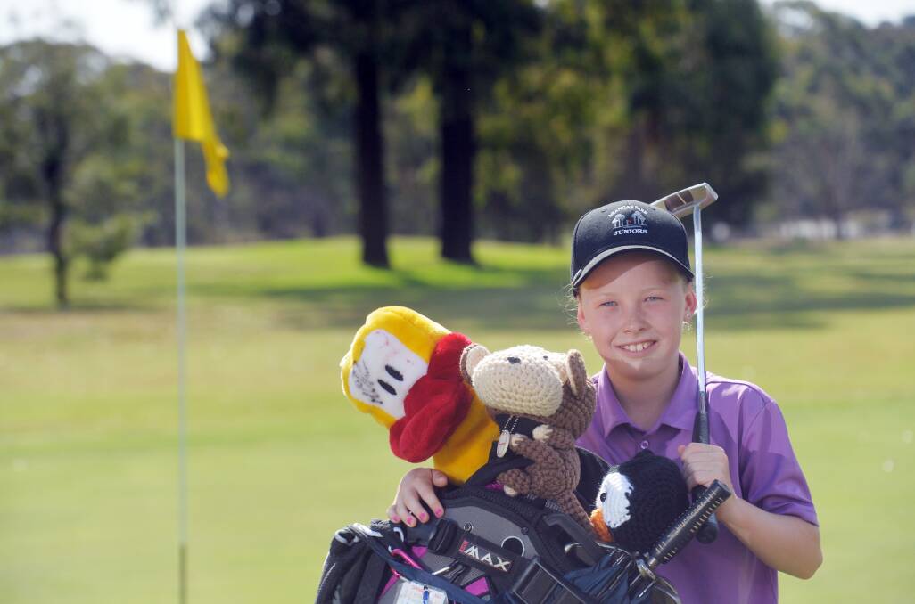 Jazy Roberts' golf bag is almost as big as she is. Picture: BRENDAN McCARTHY