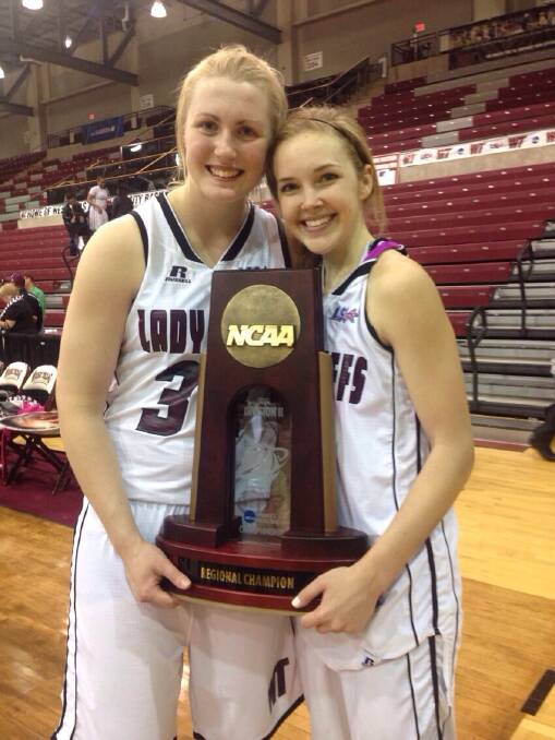 Lady Buffs team-mates Maddison Wild and Casey Land with the regional champions trophy. Picture: SUPPLIED