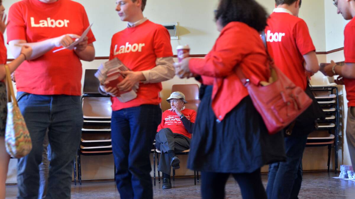Start of the ALP election campaign from Trades Hall, Bendigo. Amidst the swirl of activity before a mailbox drop, Colin Cleary amember since 1972 takes it all quite calmly.
Picture: BRENDAN McCARTHY