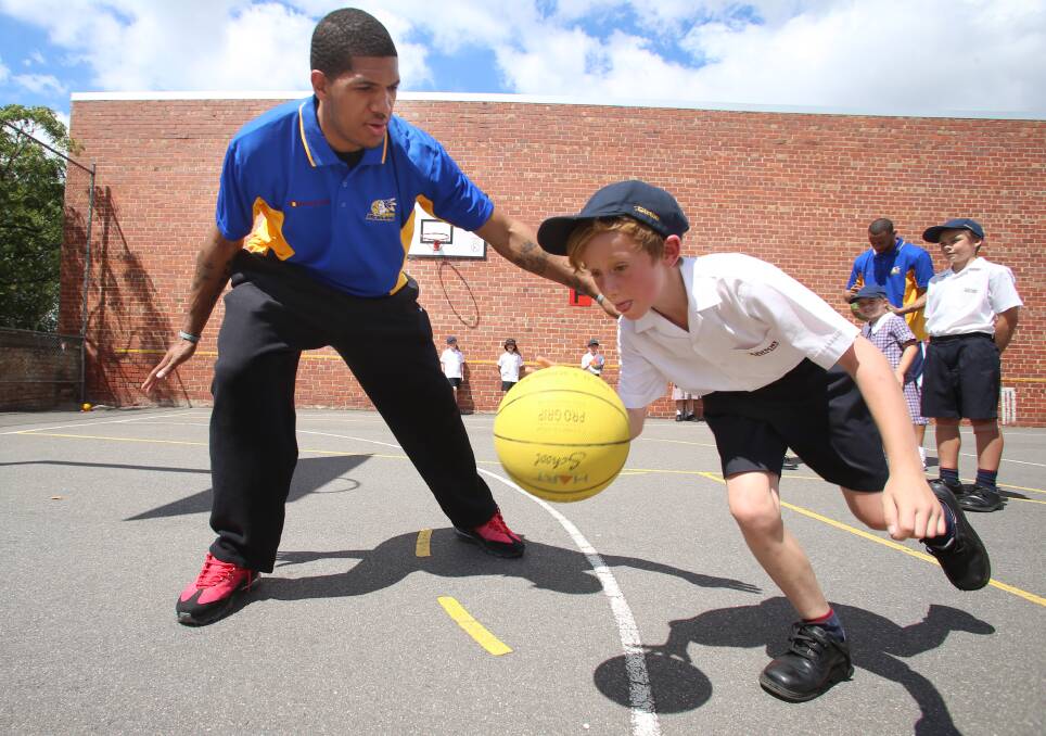 Girton Grammar School is launching its Basketball Excellence Academy
Mac Hilson 140cm goes around Dustin Salisbery 195cm
Picture: PETER WEAVING