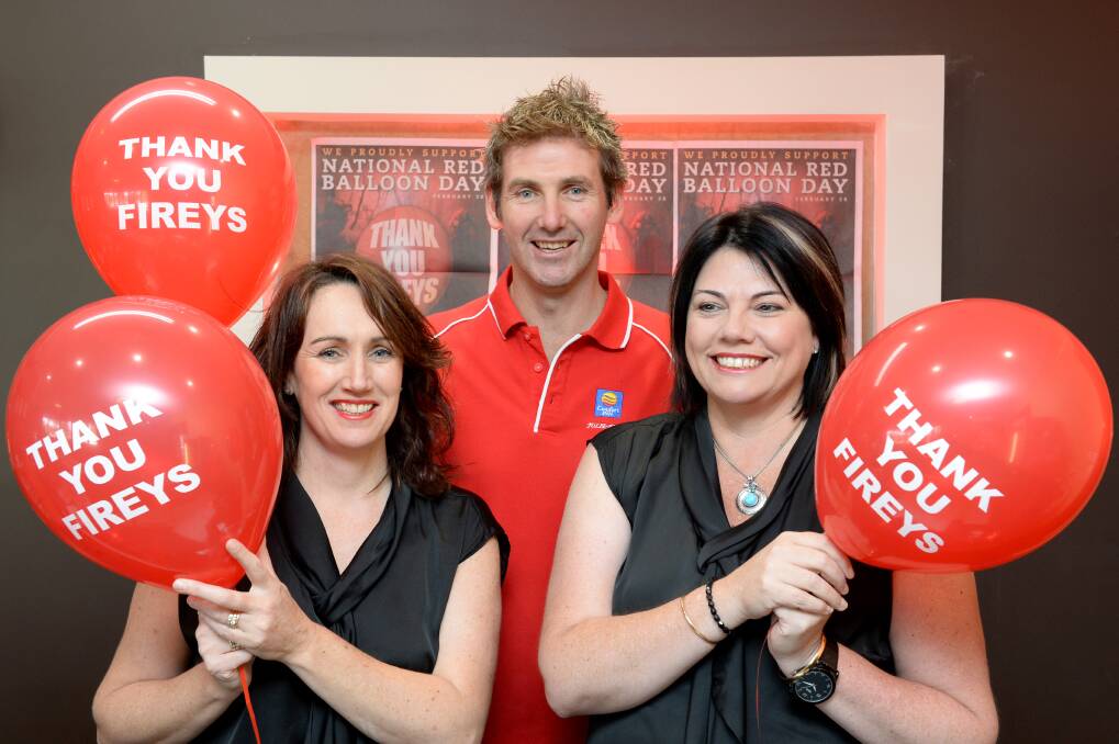 Owners Jenny Lewis-Jones and Tyrone Jones, and Nicole Garcia throw their support behind National Red Balloon Day. Picture: JIM ALDERSEY
