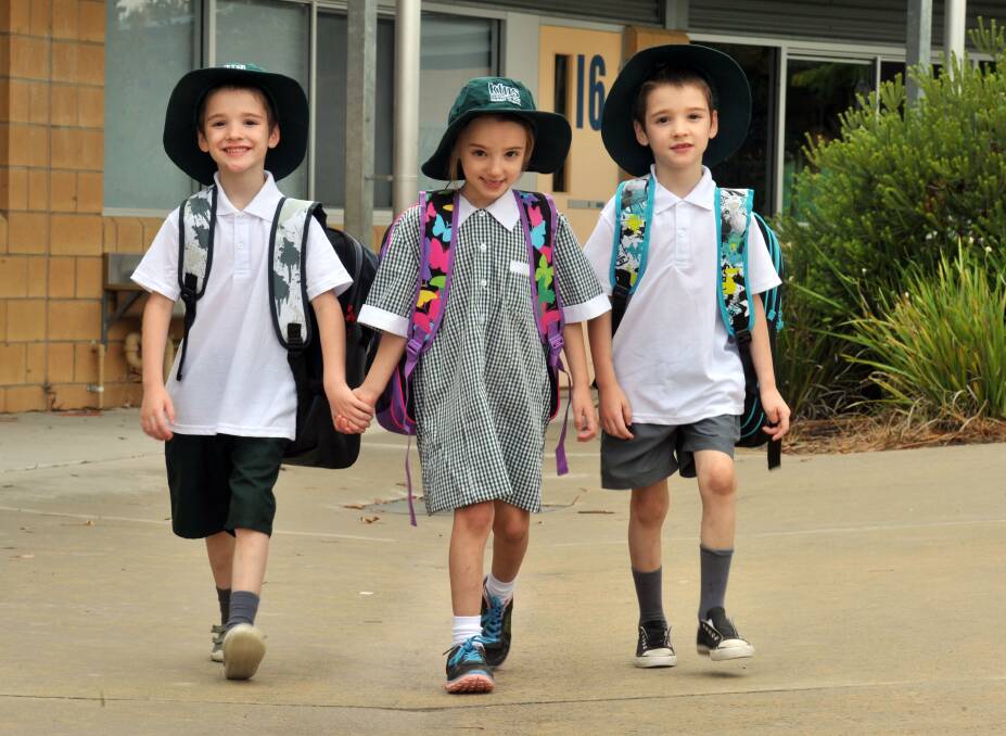 CREATING HISTORY: Cooper, Skylar and Dylan Rooney in their new uniforms. Picture: BRENDAN McCARTHY
