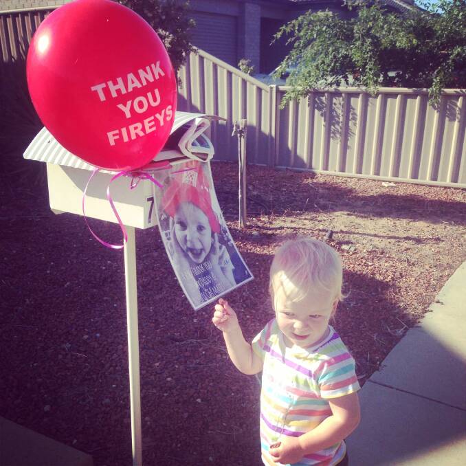 Hannah Torney, 20 months, supports the firefighters. 