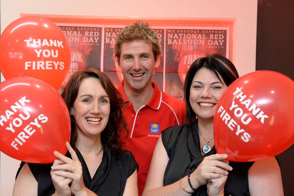 Owners Jenny Lewis-Jones and Tyrone Jones, and Nicole Garcia throw their support behind National Red Balloon Day. Picture: JIM ALDERSEY
