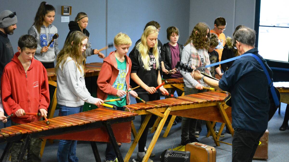 JAM SESSION: Jon Madin teaches a group of students how to play the marimba by leading a workshop.