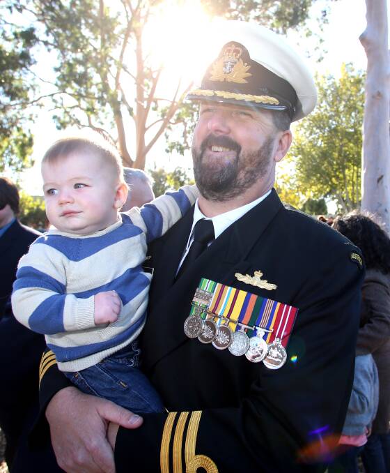 FAMILY: Commander Joshua Wilson and his youngest son Ferghus. Picture: GLENN DANIELS