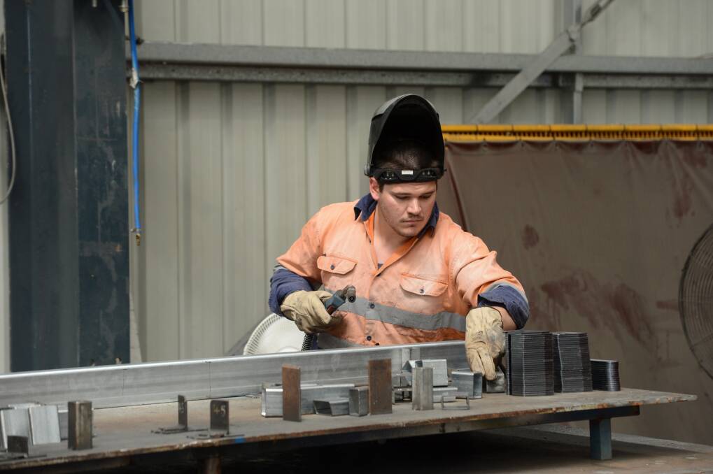 Welder Luke Percival from the Australian Turntable Company in the factory where the temperature can rise well above the outside air temperature. Picture: JIM ALDERSEY