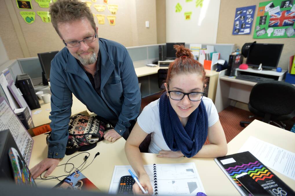 HELP: Mentor Jim Lowie helps Gabrielle Lock with her studies at NET school. Pictures: BRENDAN McCARTHY
