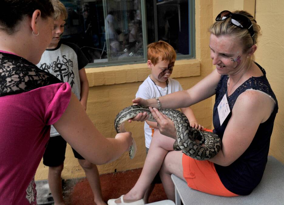 Kim Morris from Tooko Wildlife Displays and Sam the carpet python. Picture: JODIE DONNELLAN 
