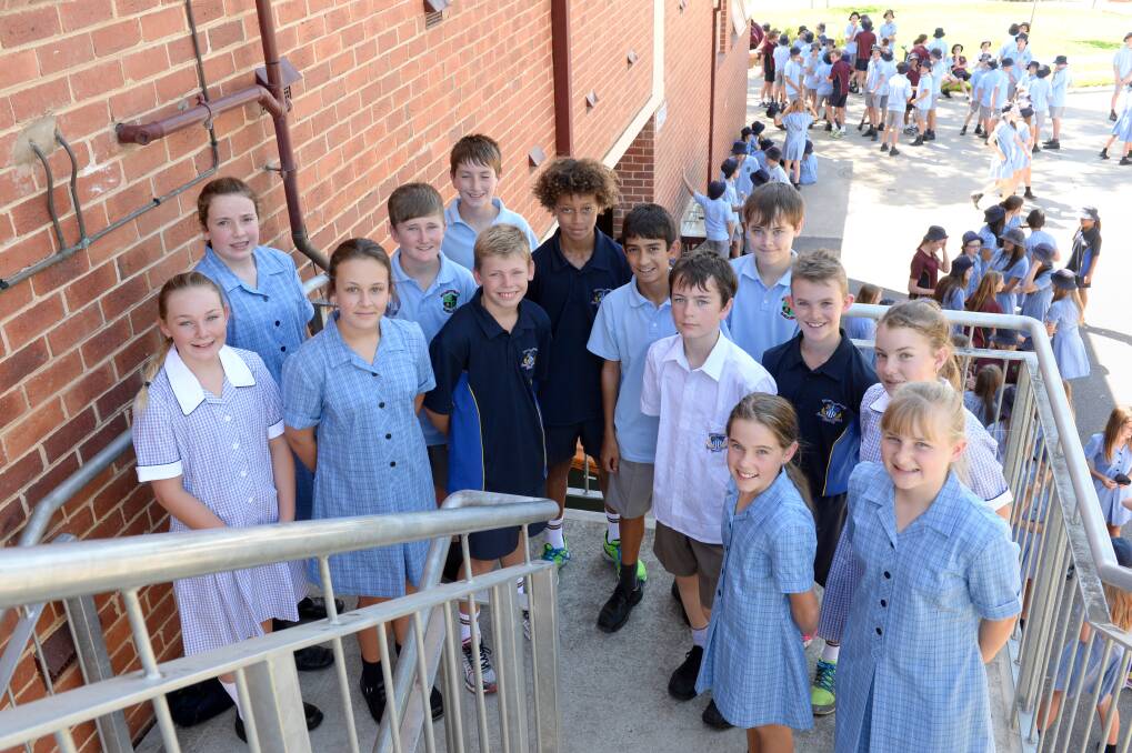 Year 7 students in the Marist College uniforms and the Catholic College Bendigo uniform. Picture: JIM ALDERSEY