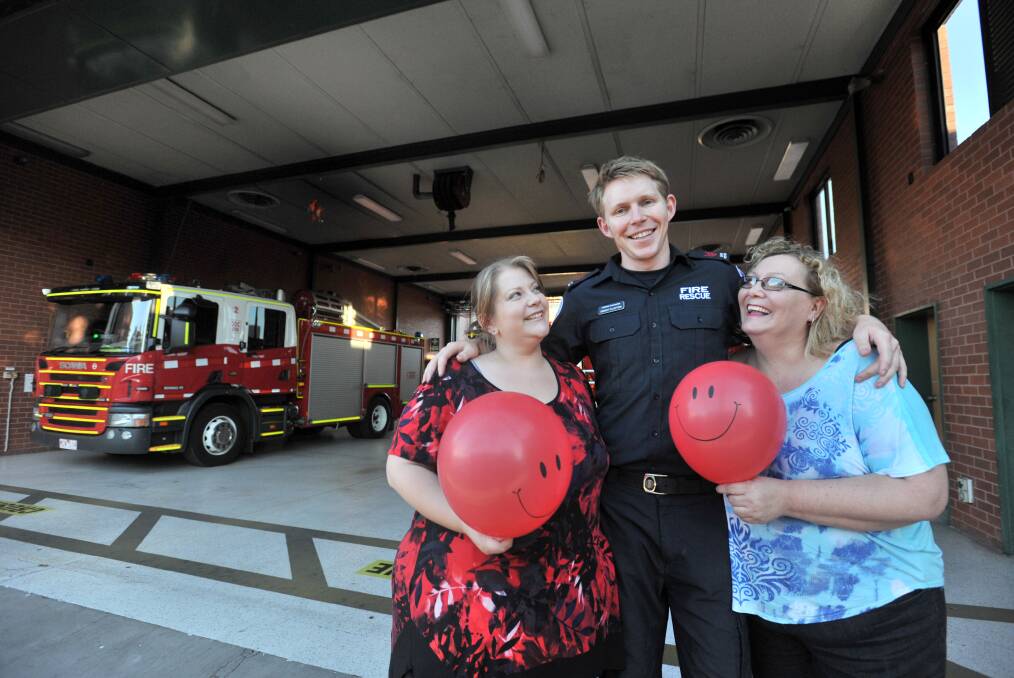 Aleasha Gilbert and Jody Hardiman with firefighter Brent Clayton. Picture: JODIE DONNELLAN 
