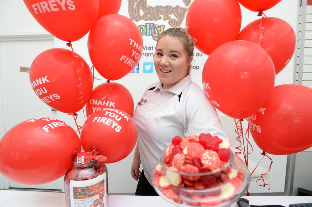 RED: Lolly expert Monique Bailey with the official red balloons and red lollies. Picture: JIM ALDERSEY
