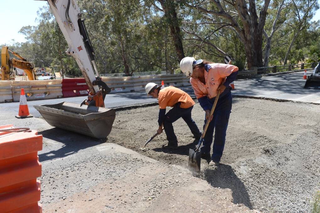 Thommo and Darcy Hayen working on the road just outside of Axedale is hot work on a Summer's day. Picture: JIM ALDERSEY
