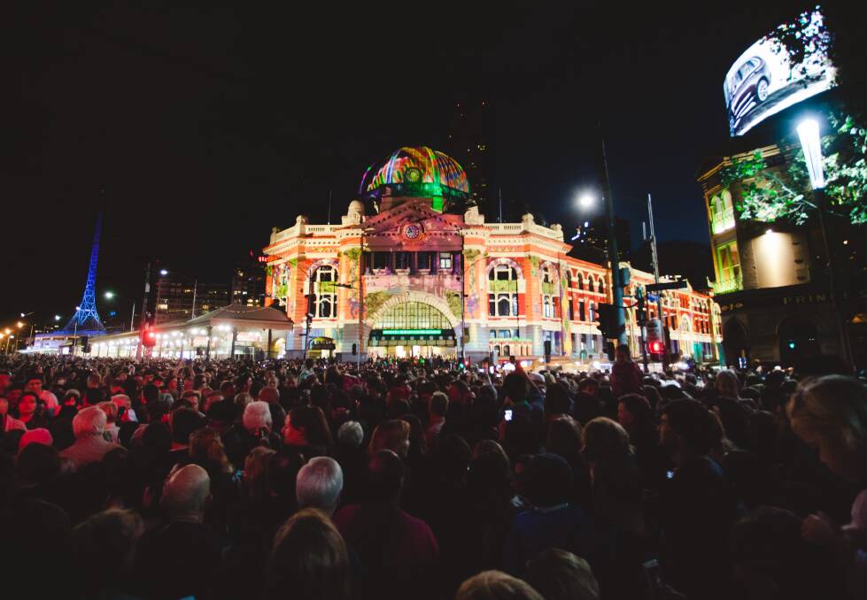 SHINING SUCCESS: Hundreds of thousands of people take to Melbourne's streets for the second installment of White Night. Picture: THE AGE