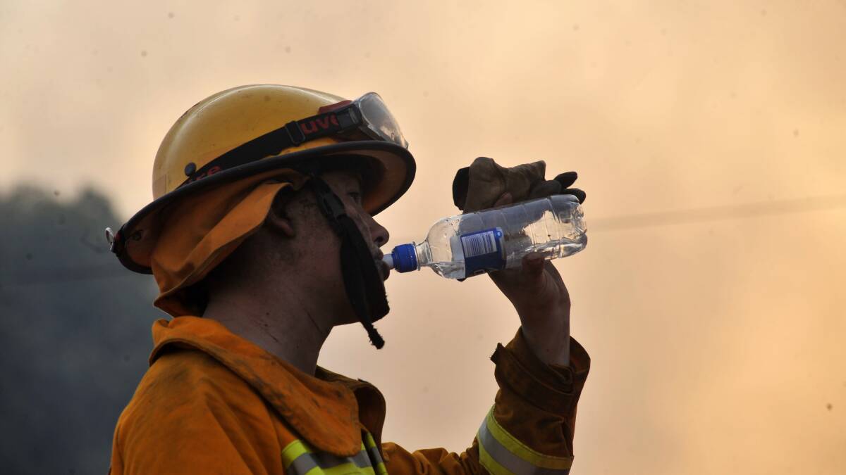 FEBRUARY 7, 2009: A firefighter shows the strain of the long day. Picture: Peter Hyett