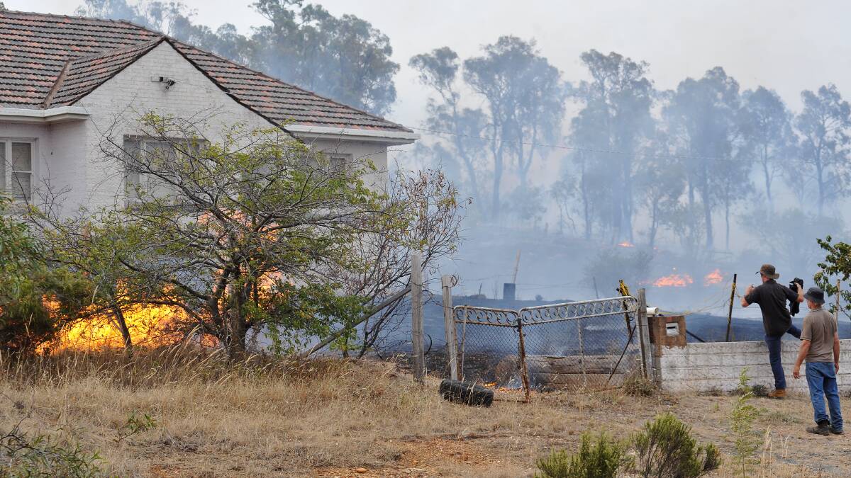 FEBRUARY 7, 2009: Fire threatens a home in Inglis Road, Ironbark. Picture: Julie Hough
