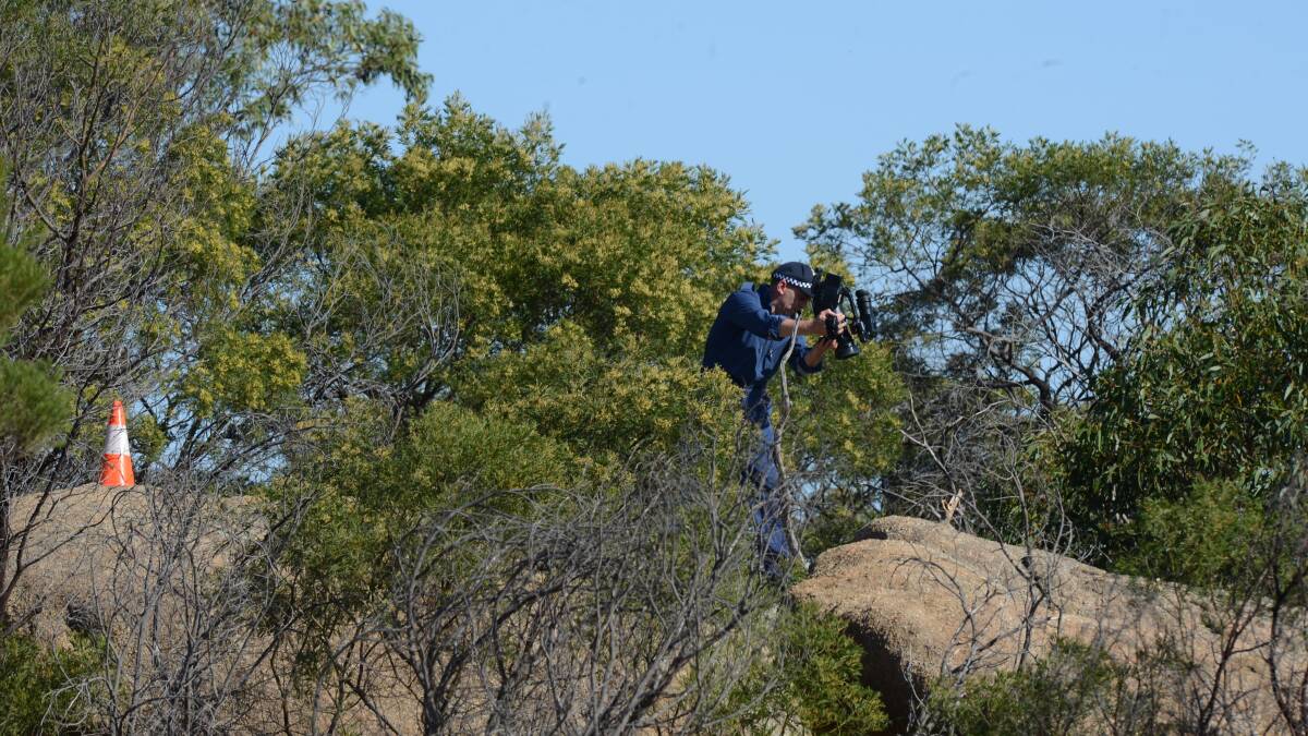 Police erect equipment near the top of Mount Korong where a body has been found, believed to be Wayne Amey. Picture: JIM ALDERSEY