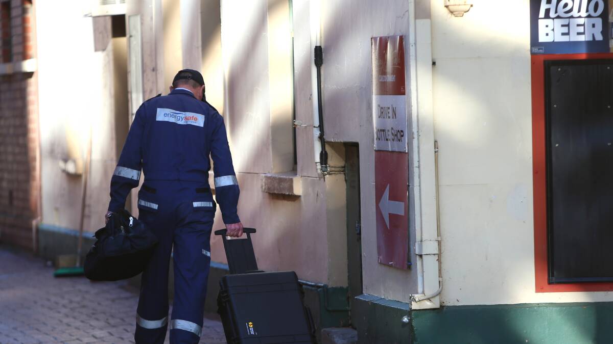INVESTIGATE: A man from Energy Safe, Victoria, enters the hotel.