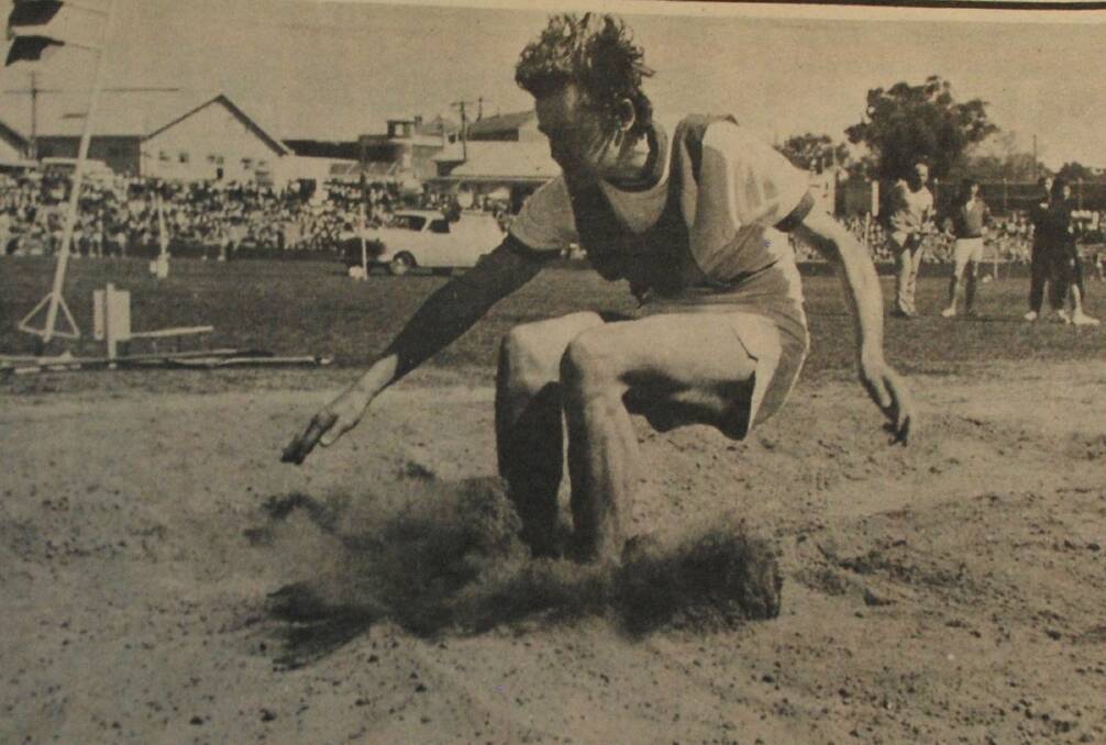 Finalist Peter Parnabi of Castlemaine High hits the sand pit during the hop, skip and jump competition.