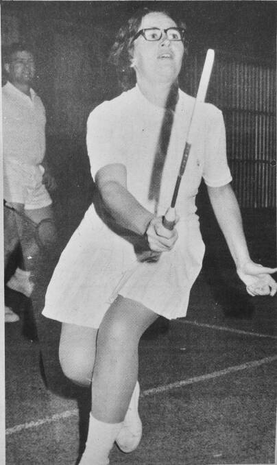 A grade pennant player Beryl Angove plays a forehand shot. Her husband Ron looks on during a recent badminton match in Bendigo