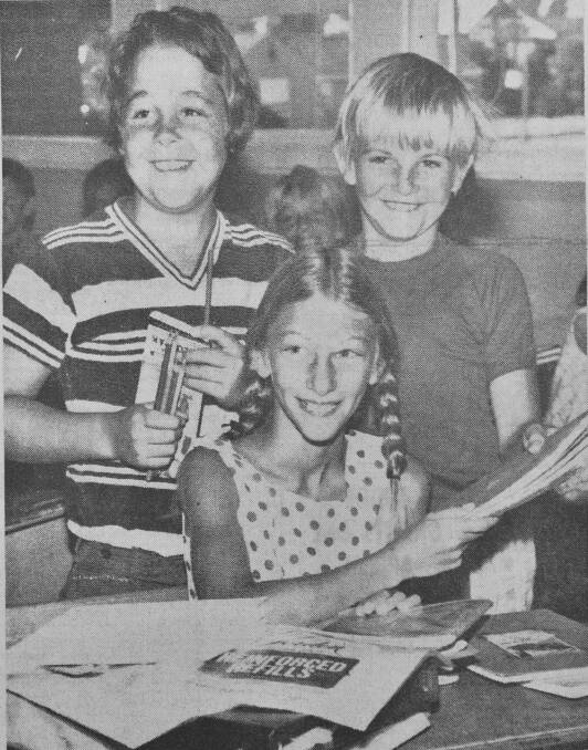 Bendigo East Primary School students Robert Holden, Dianne Phelan and Miles Wilkie unpacking their books on the first day of school.