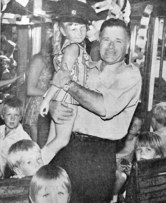 Tram conductor Len Caughlan places his hat on school girl Lyn Edward’s head, as the class took a tram ride to farewell the last trams running in Bendigo.
