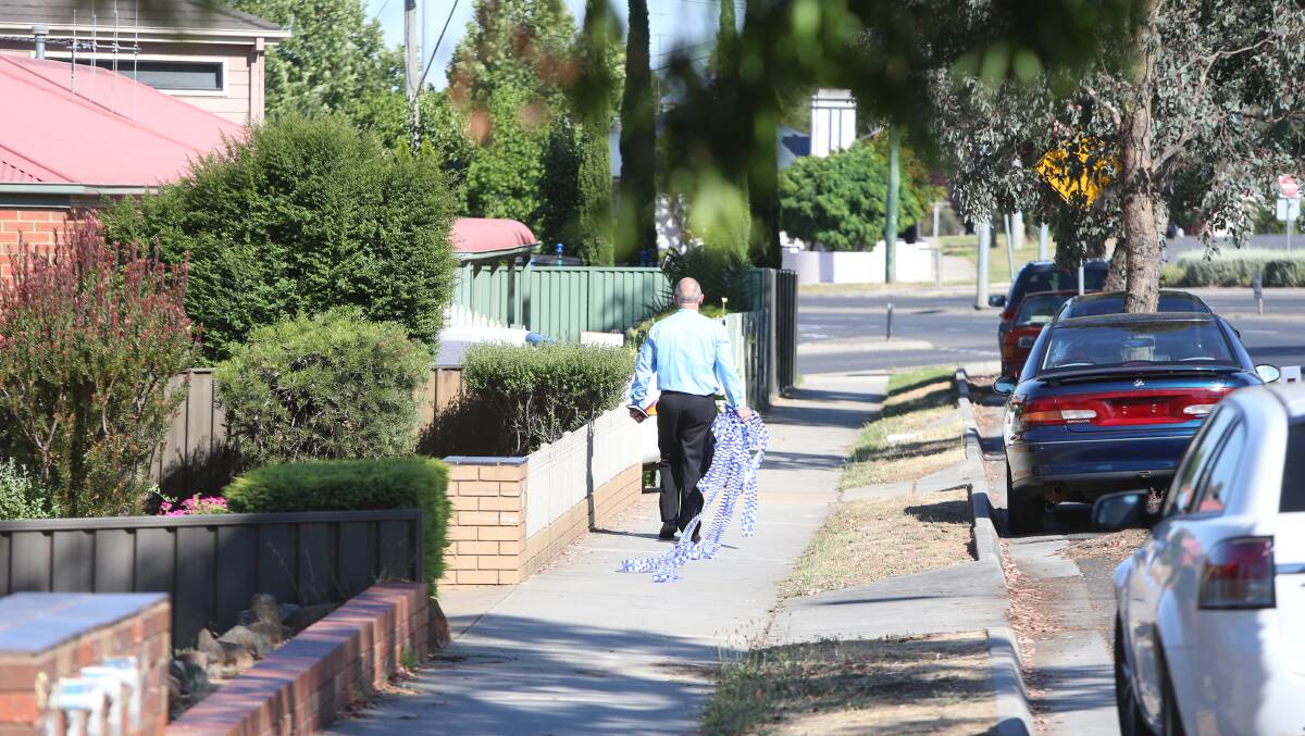 Police carry police tape on Condon St, Kennington, this morning. Picture: GLENN DANIELS