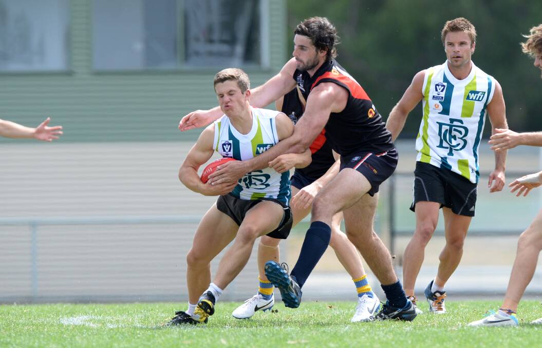 Daniel Toman is tackled by Jeremy Lambden.