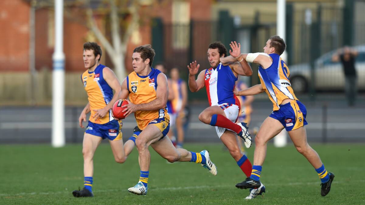 EXCITEMENT MACHINES: Mitch Dole puts a shepherd on for Brodie Filo in Bendigo's inter-league win over Gippsland last Saturday.