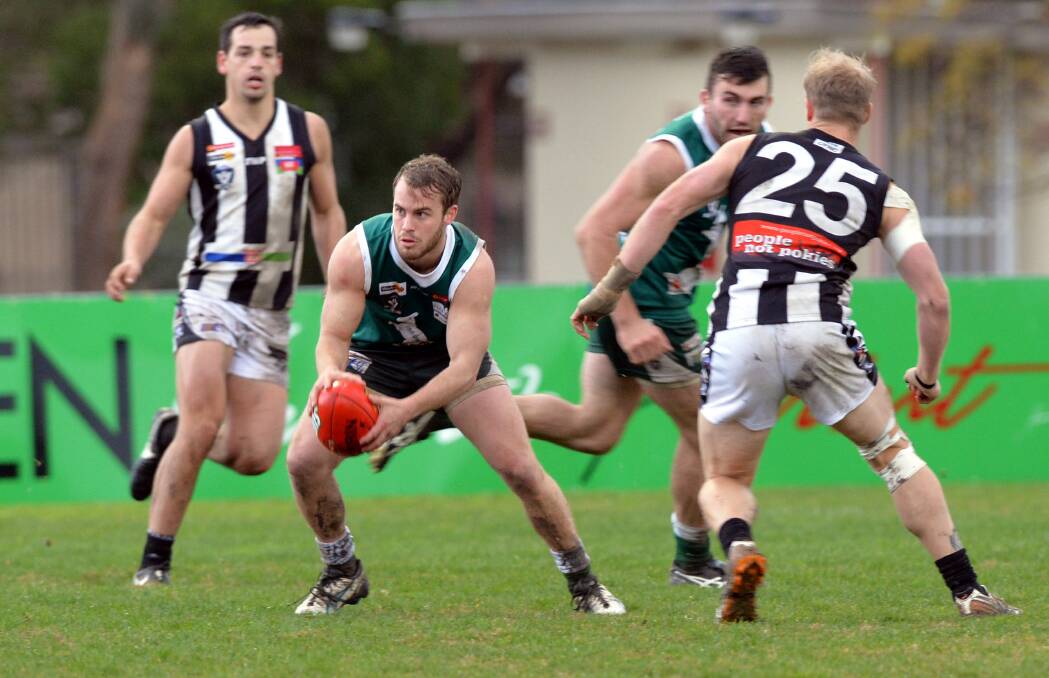 POISE: Kangaroo Flat's Corey Greer with possession against Castlemaine on Saturday. Picture: BRENDAN McCARTHY