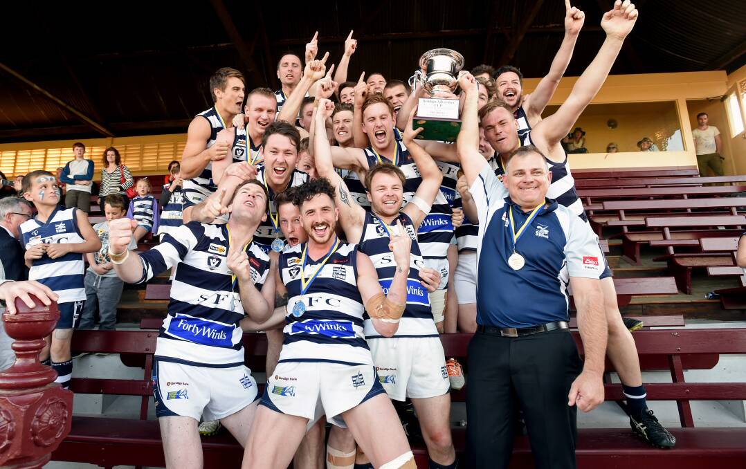 2014 PREMIERS: Strathfieldsaye holds aloft the BFL premiership cup for the first time.