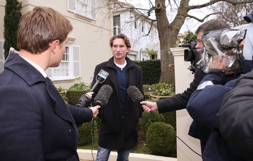 QUESTIONS: Essendon's James Hird during one of his many Toorak mansion driveway media spots during the 2013 season. Picture: GETTY IMAGES