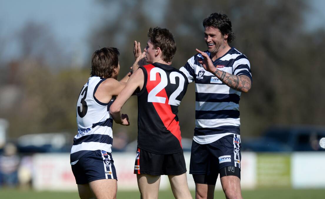 FLYING START: Lockington-Bamawm United coach Adrian Dohnt (No.13) and Jonathan Hay celebrate one of the Cats’ five goals in the first quarter of Saturday’s preliminary final. Pictures: JIM ALDERSEY