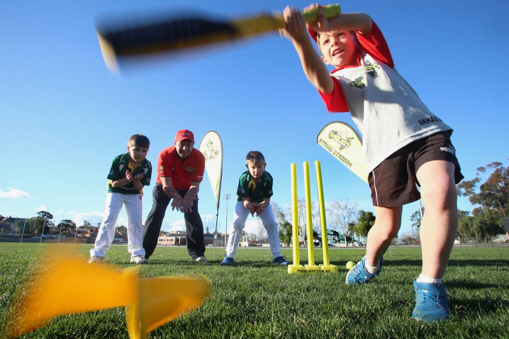STYLISH: Young batsman Oliver Ryan goes whack in front of Cooper Orton, Bendigo District Cricket Association junior co-ordinator Tony Ryan and Noah Cain ahead of the upcoming T20 Blast season. Picture: PETER WEAVING
