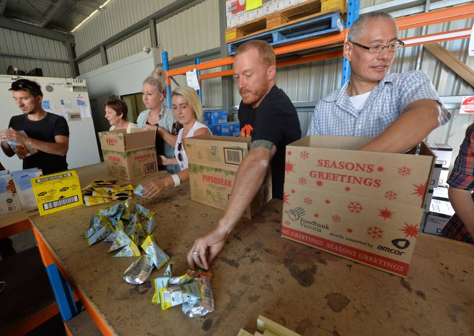 Volunteers pack boxes at Bendigo Food Store.