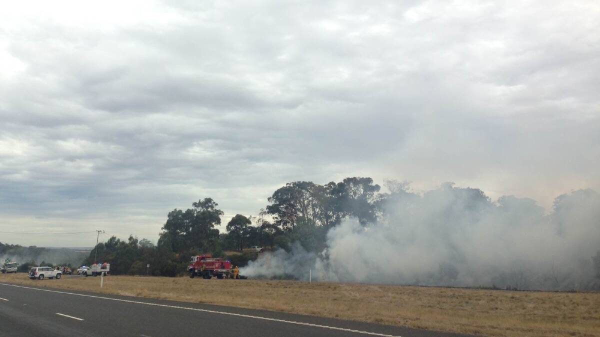 Car engulfed in flames, sparks bushfire