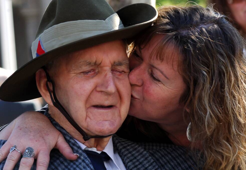 EMOTIONAL: Herb Dixon gets a hug from daughter Karen Packham who travelled from Alice Springs to spend Anzac Day with her dad. 2006. Picture: BRENDAN McCARTHY
