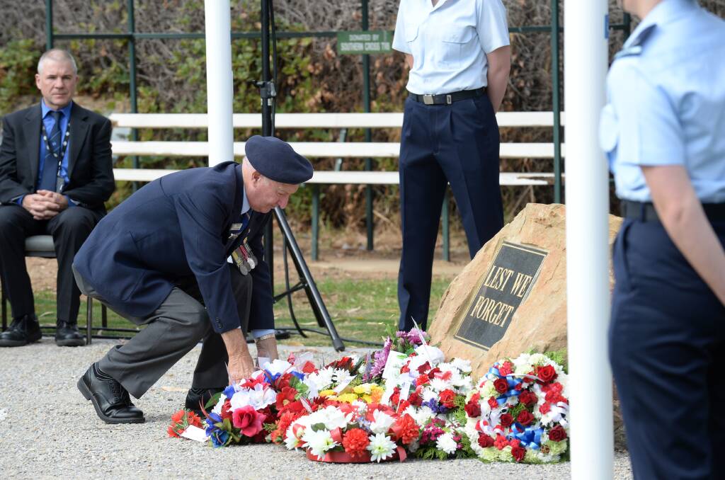 John Meager lays a wreath. 