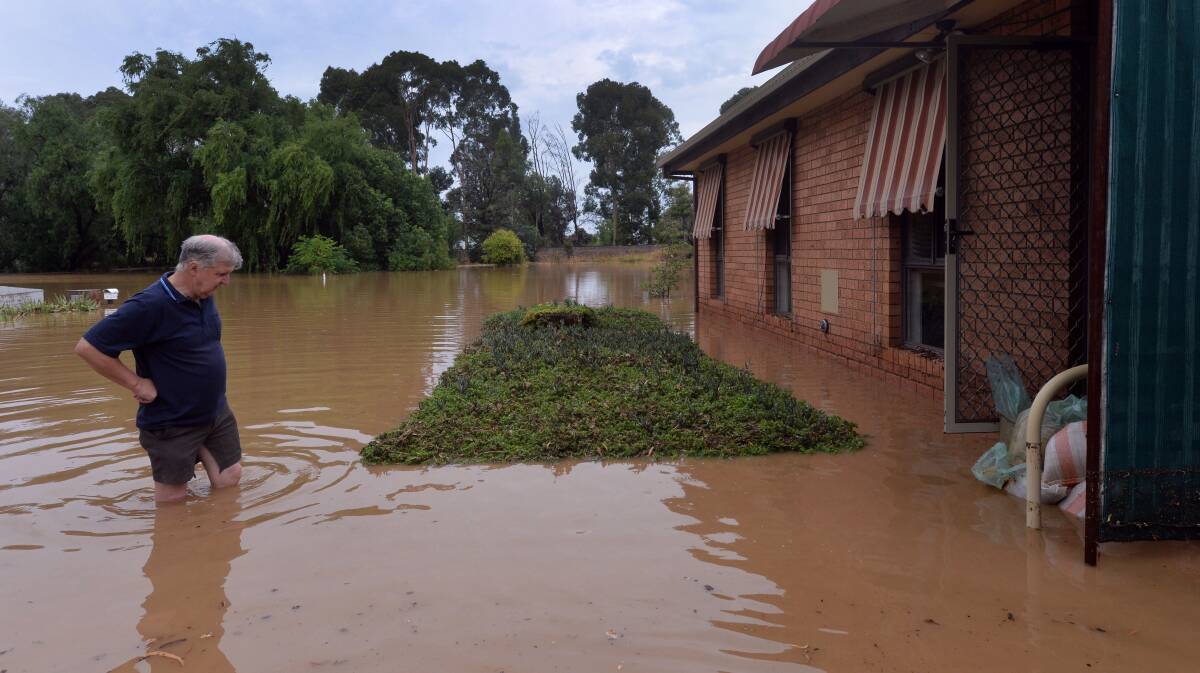 DAMAGE: Laurie Fitzgerald surveys the flood damage to his unit in Victoria Lane, Eaglehawk. Picture: BRENDAN McCARTHY