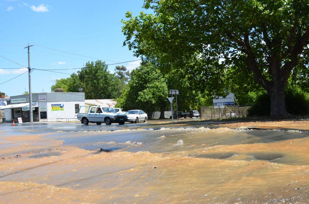 BURST: Water gushes across the road from a burst water main in Barker Street, Castlemaine. Picture: CASTLEMAINE MAIL