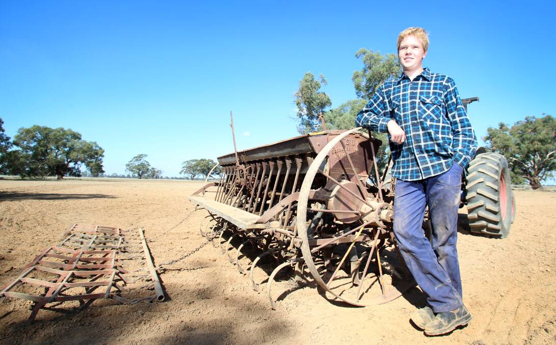 Nick Collins and his grandfather's 1920s H.V McKay seeder he spent eight weeks restoring.