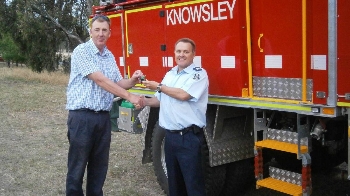 HAND-OVER: CFA district 02's Chris Jacobson with Knowsley Captain Rob Long. Picture: SUPPLIED