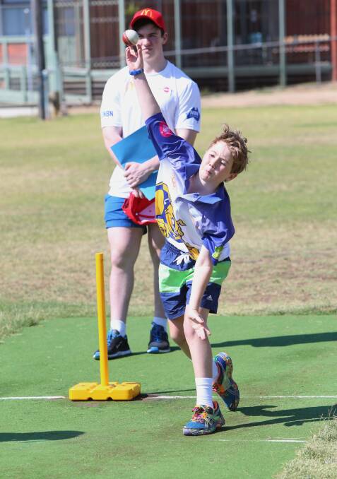 McDonald's Summer Cricket Camp at Ewing Park Bendigo.
Blake Walker bowling with assistant coach Tom Goulding watching on.
Picture: PETER WEAVING