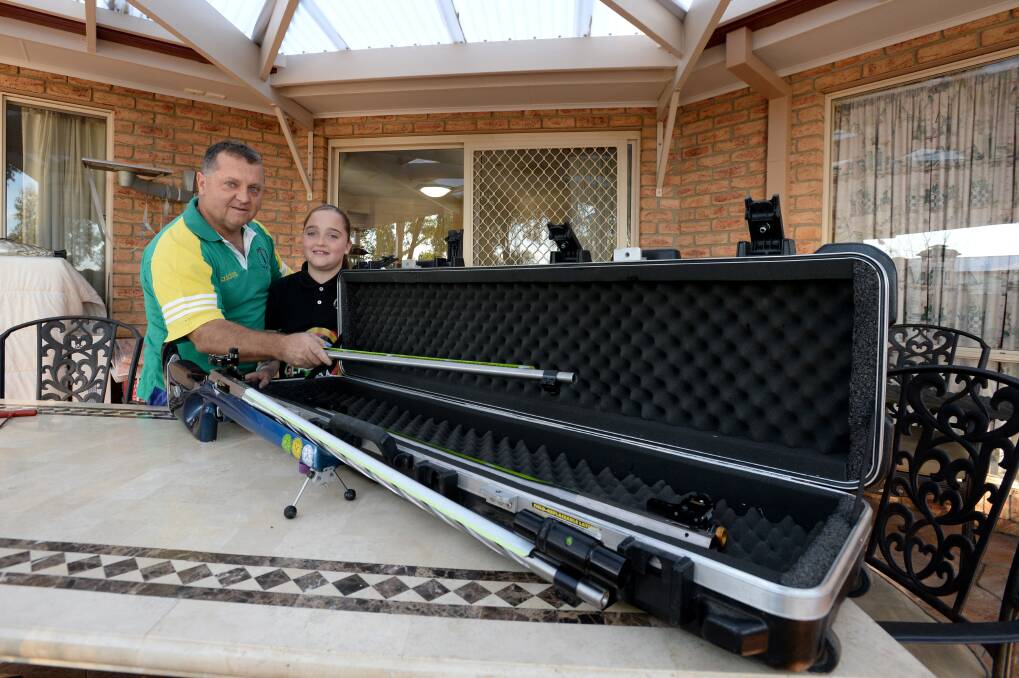 READY TO FIRE: Geoff Grenfell gets help packing from his daughter Aleisha, 10, ahead of the Commonwealth Games. Picture: JIM ALDERSEY