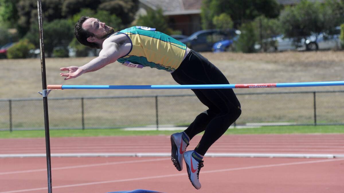 Stephen Bullock jumps over the high jump. Picture: JODIE DONNELLAN 
