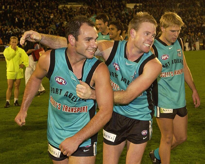 Guerra, Nick Stevens and Kane Cornes after the Power defeated Collingwood in round nine, 2002. Picture: GETTY IMAGES