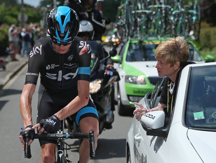 INJURED: Chris Froome receives medical treatment. Picture: GETTY